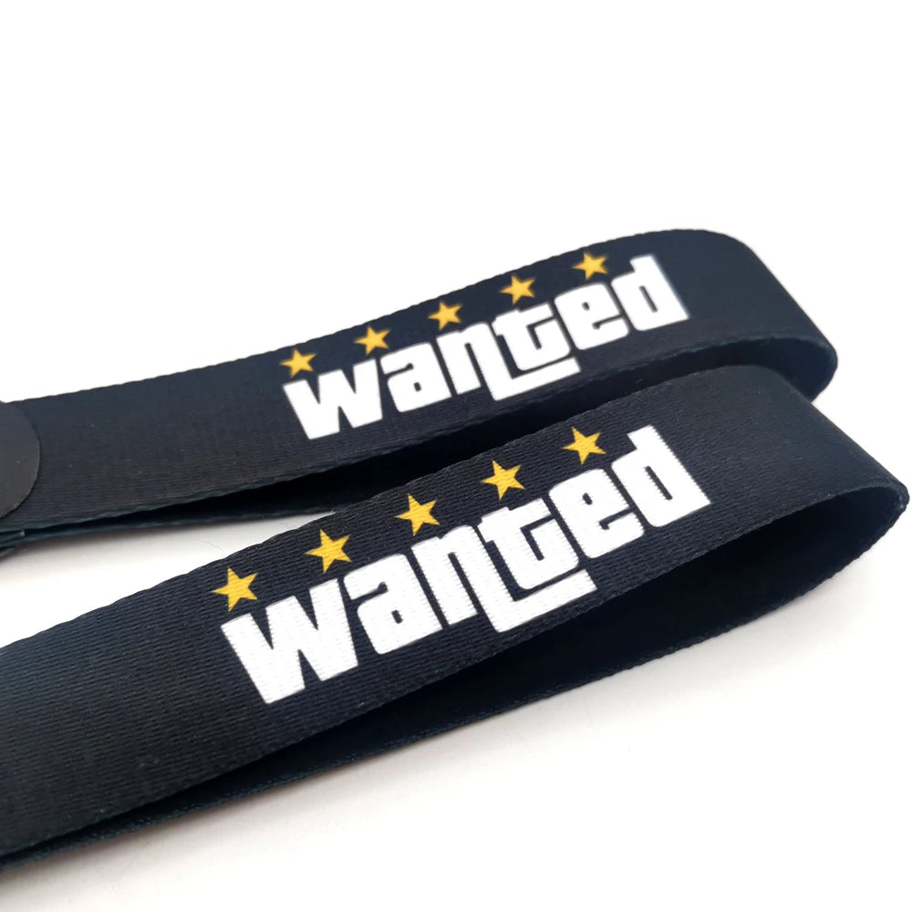 Black nylon keychain with white text and yellow stars embroidered on it