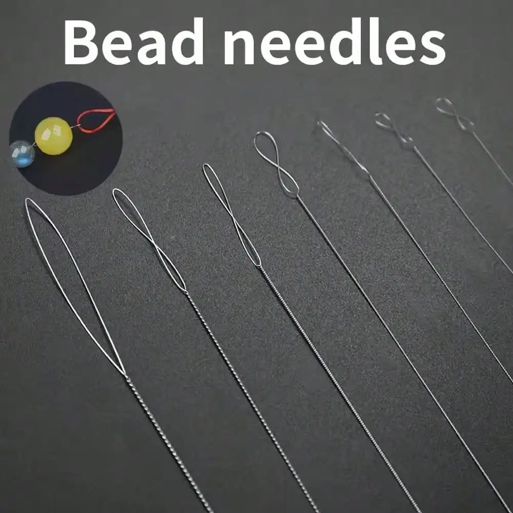 A set of ultra-fine beading needles for jewelry making displayed on a dark surface.