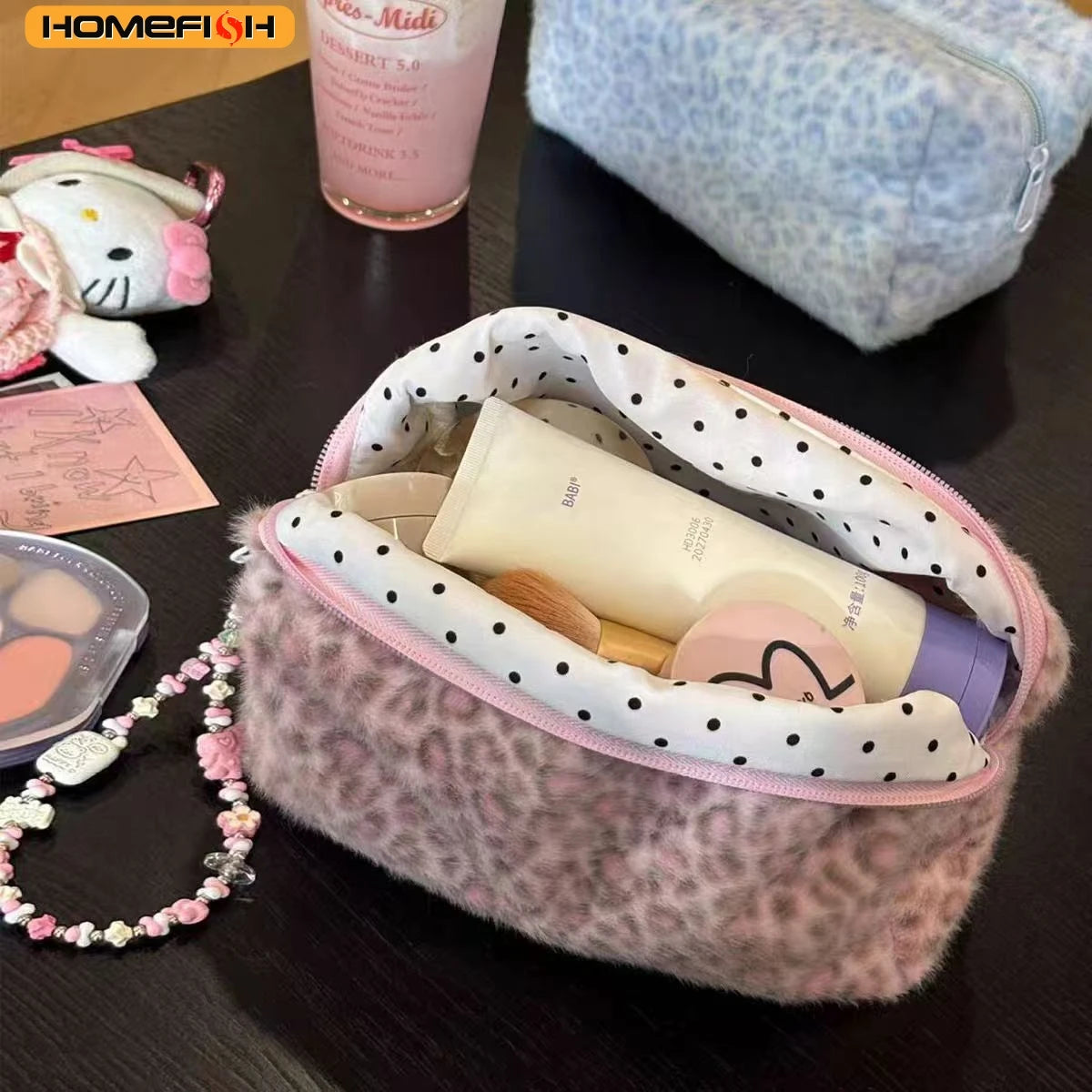 A leopard print cosmetic bag with a plush lining is shown next to a pink liquid and a white plush toy.
