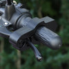 Close-up of a black motorcycle handlebar brake lock anti-theft security device.