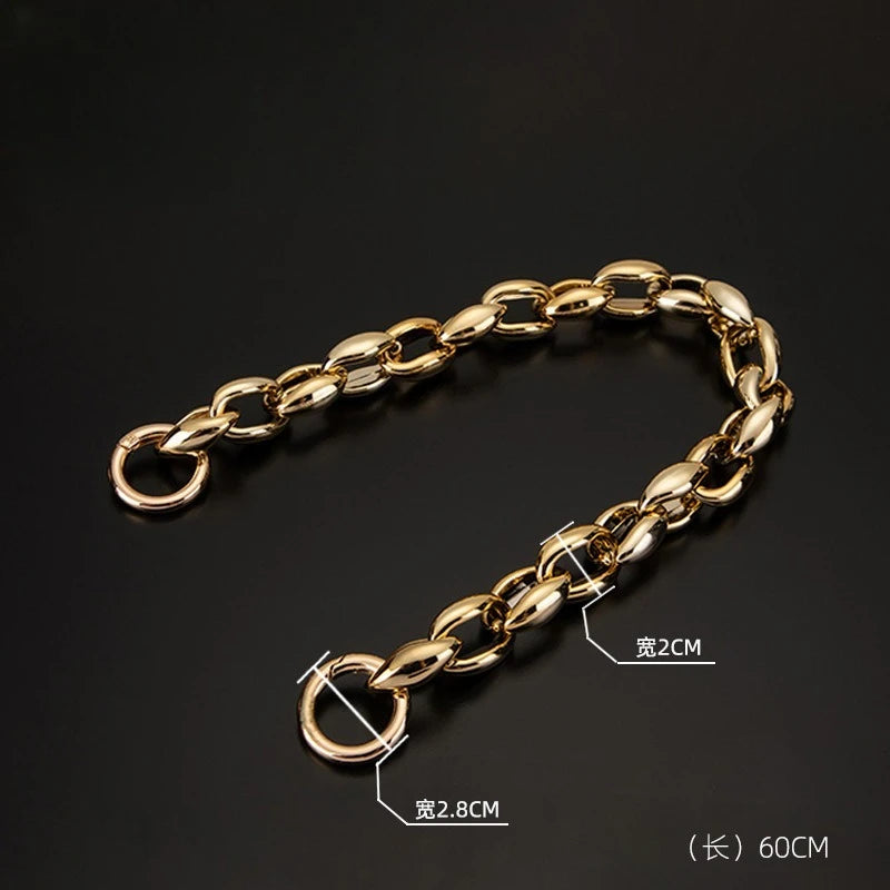 A gold-colored acrylic chain strap measuring 60cm is displayed against a dark background.