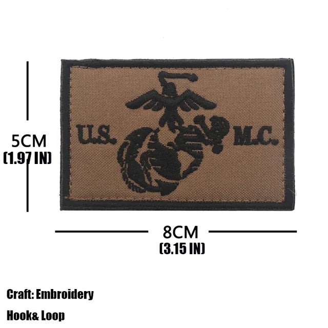 A brown embroidered tactical patch featuring an eagle design and the text US M.C.