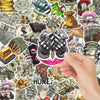 A hand holds a sticker pack featuring various funny money cartoon graffiti stickers on a background of currency and gold.