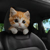A cute orange tabby kitten is featured on a car headrest pillow cover.