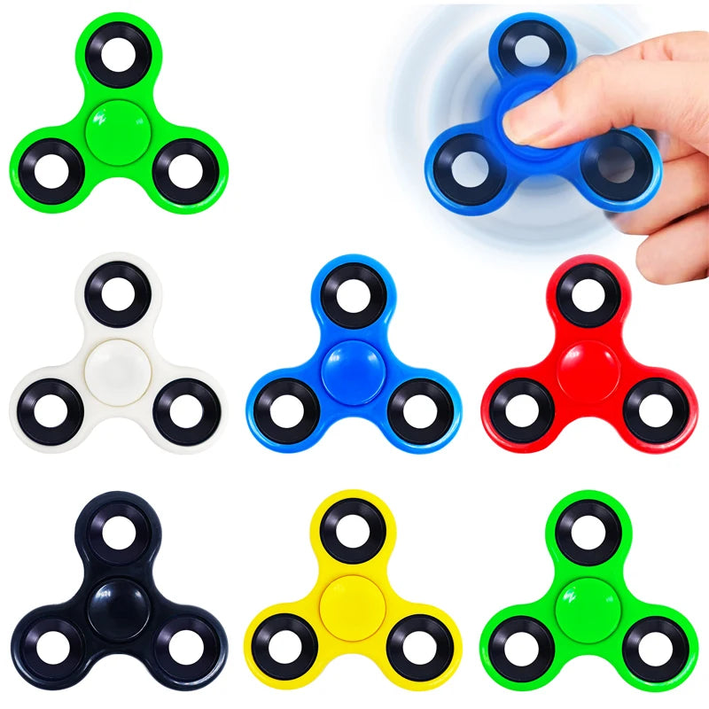 A collection of colorful smooth-spin fidget spinners in green, blue, white, red, and yellow.