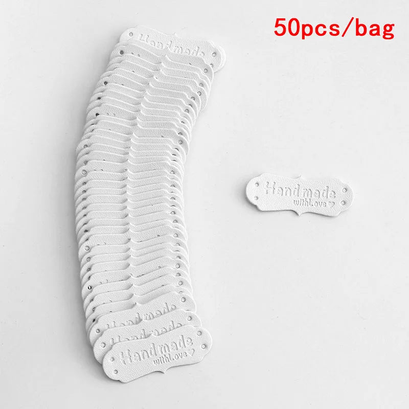 A stack of 50 white PU leather hand-made sewing labels with 'Made With Love' text.