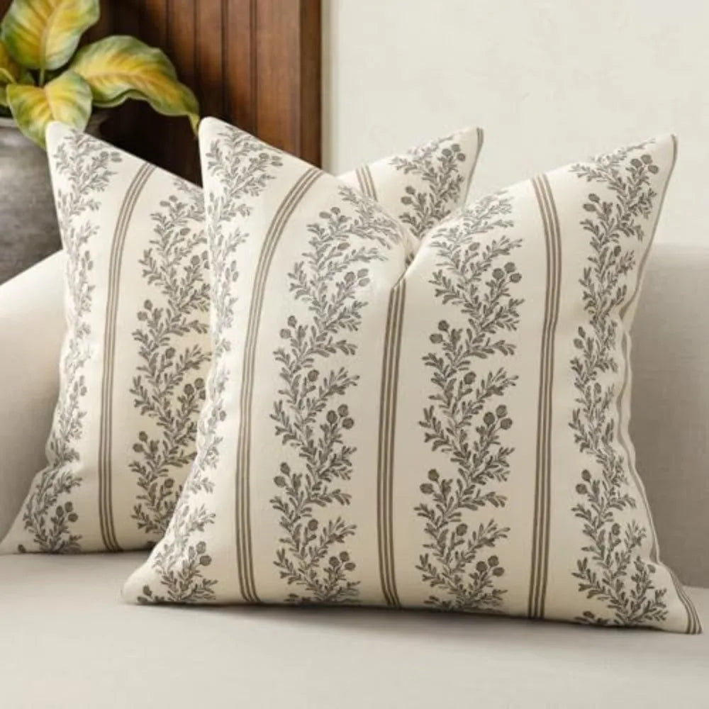 A vintage striped floral throw pillow cover with gray and green botanical patterns on a light background.