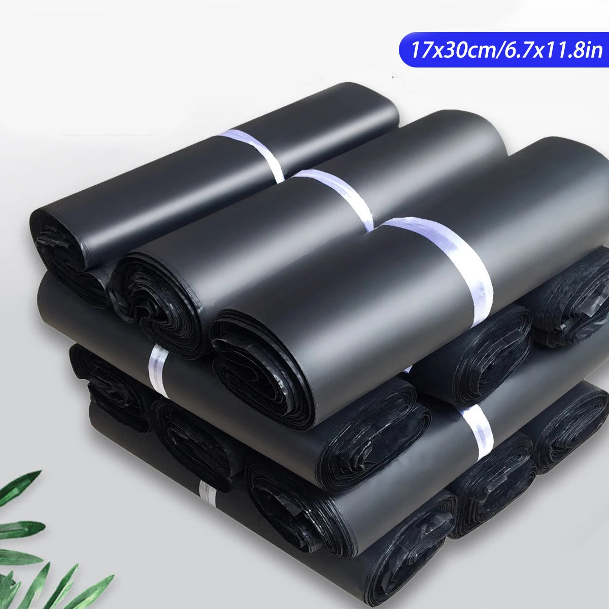 A stack of black self-seal poly mailer bags rolled up for shipping.