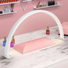 A white half-moon LED arc desk lamp illuminates a pink cosmetic tray on a marble surface.
