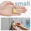 A hand holds a small yellow padlock with keys, demonstrating its size for security.
