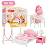 A pink and white miniature dollhouse furniture set featuring a bed, dresser, and mirror for a child's room.