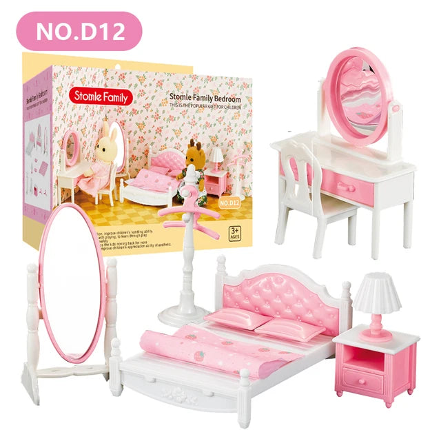 A pink and white miniature dollhouse furniture set featuring a bed, dresser, and mirror for a child's room.