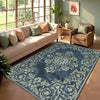 A dark blue and cream patterned cowhide print area rug in a modern western style placed in a bright living room.