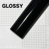 Glossy black carbon fiber vinyl wrap film shown diagonally on a white grid background.