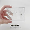 A hand holds a clear cosmetic bag for waterproof storage of makeup brushes and other items.