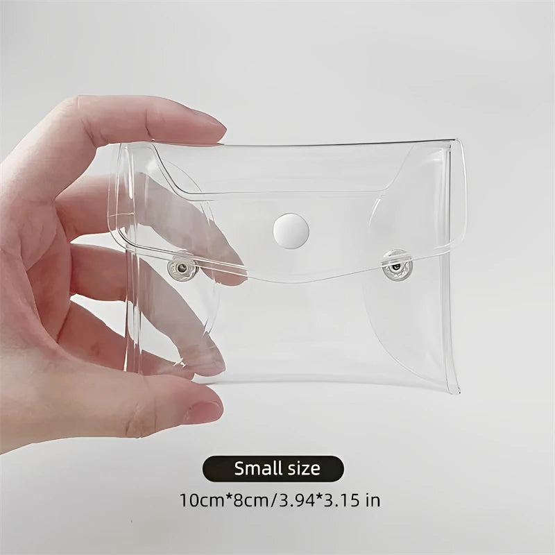 A hand holds a clear cosmetic bag for waterproof storage of makeup brushes and other items.