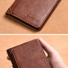 A brown slim PU leather card holder wallet being held in a hand on a tan background.