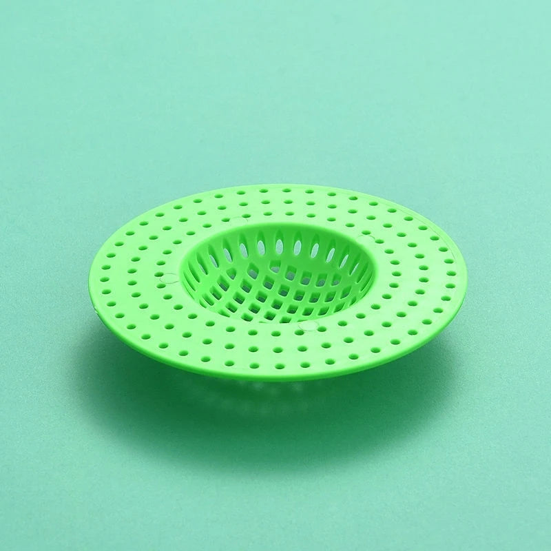 A bright lime green silicone sink drain filter strainer with a perforated circular design.