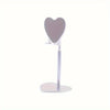 A silver adjustable heart-shaped stand for holding a phone or tablet.