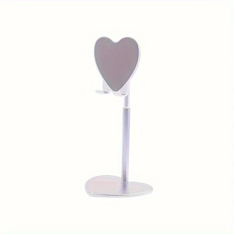 A silver adjustable heart-shaped stand for holding a phone or tablet.