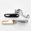 Three metal zipper pulls in silver, black, and gold finishes displayed on a white background.