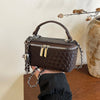 A dark brown woven PU leather crossbody bag with silver chain details is held against a light background.