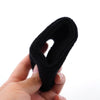 A hand is holding a black brake fluid reservoir cover sock for a Yamaha R1 R6.