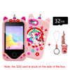 A pink kids smart phone toy with dual cameras and learning features, next to a 32GB memory card.