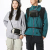 A young man and woman wearing outdoor tactical gear, including a waterproof vest and waist bag.