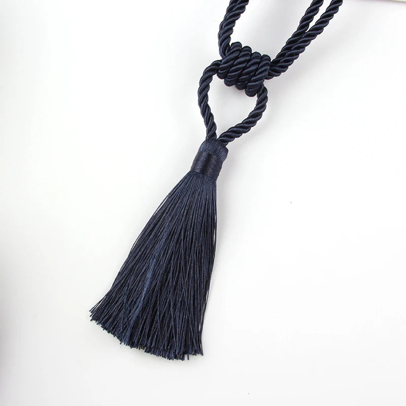 A set of two dark navy blue braided rope tassel curtain tiebacks