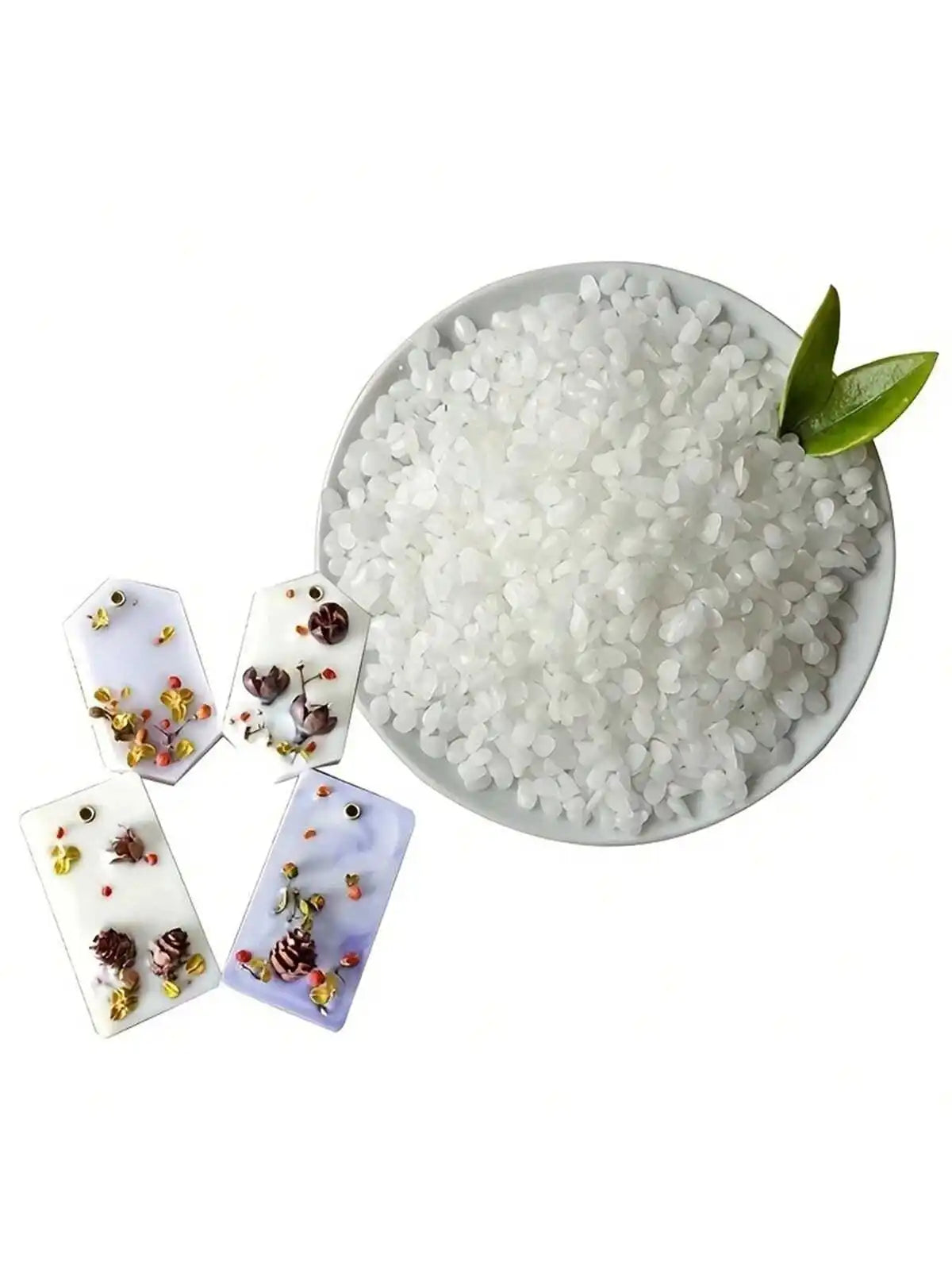 White natural soy wax granules in a bowl with small dried floral elements.