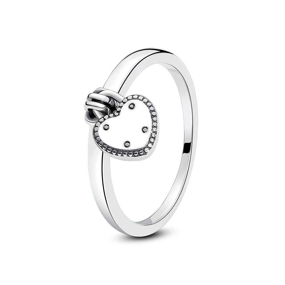 A sterling silver heart ring featuring a pendant design with cubic zirconia stones.
