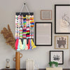 A large capacity hair bow and clip organizer with a rope hanger displaying colorful bows and clips on a wall.