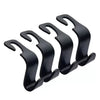 A pair of black universal car headrest hooks used as storage hangers for bags and clothes.