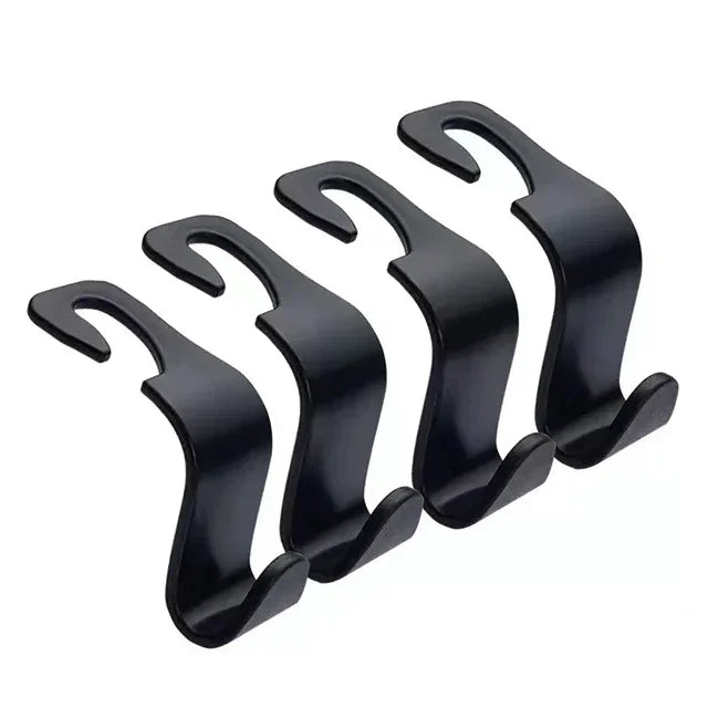 A pair of black universal car headrest hooks used as storage hangers for bags and clothes.