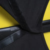 Black stretchy suitcase cover protector with black strap shown against a yellow background.