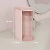 A pink clear acrylic hair accessories organizer with rotating compartments shown on a white surface.