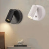 A modern magnetic rechargeable touch light fixture in matte black and white mounted on a wall.