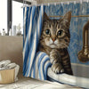 A tabby kitten looks out from under a blue and white striped shower curtain, resting on a windowsill.