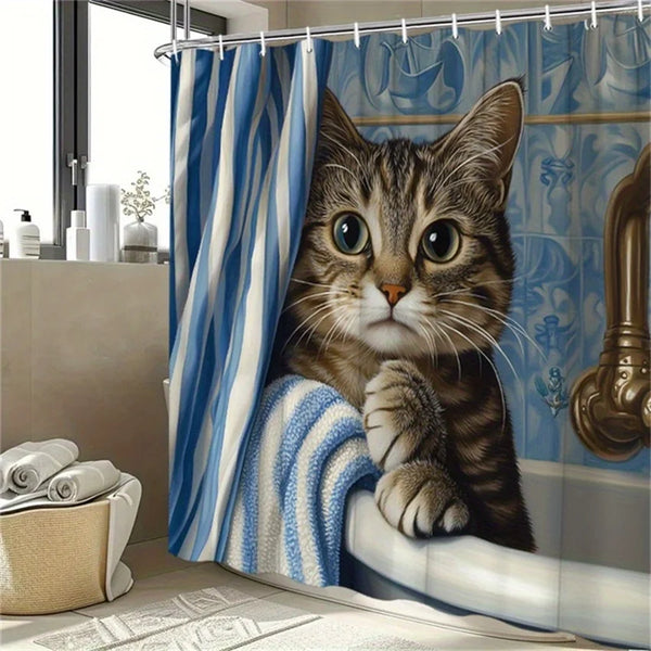 A tabby kitten looks out from under a blue and white striped shower curtain, resting on a windowsill.