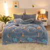 A blue plush throw blanket featuring dinosaur and star patterns is displayed on a bed with soft lighting.