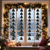 Vintage iron wind chime hanging in a window with winter greenery and candles
