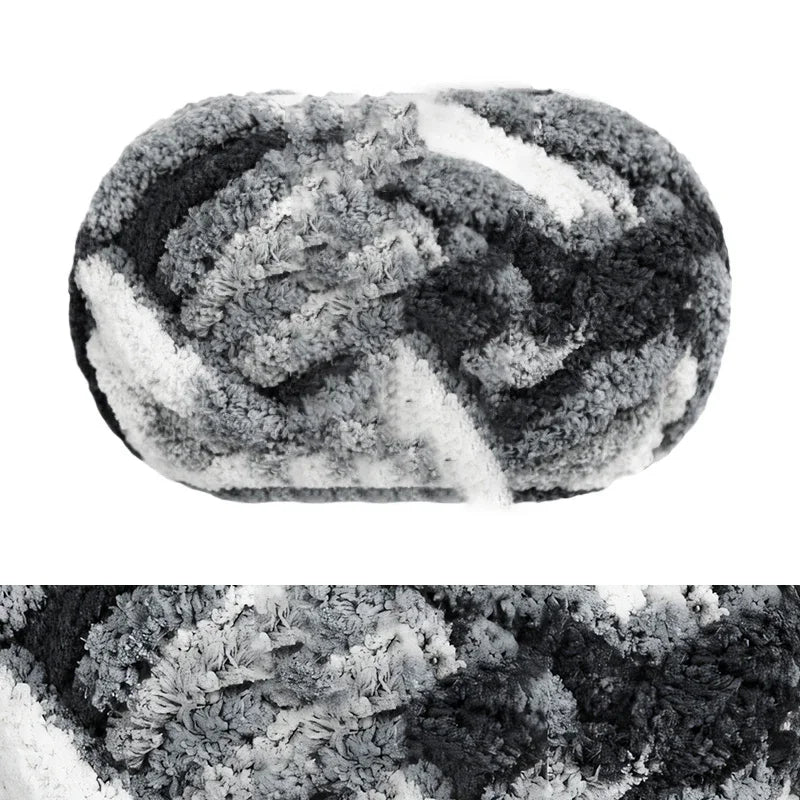 A ball of chunky chenille yarn with a dark gray and white marbled pattern.