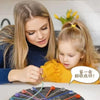 A children's rope untangle puzzle with colored ropes and pegs on a black board.