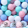 A close-up view of a variety of colorful, smooth ball pit balls in shades of pink, blue, and white.