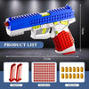 A blue and white building block toy pistol with a red grip and yellow accents, shown with accompanying parts.