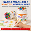 A hand holds a white plastic container of silky crayon set with 12 colors, demonstrating safe and washable non-toxic art supp