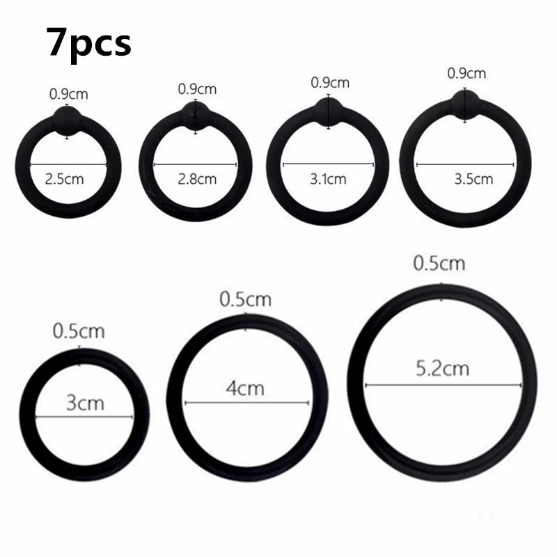 Seven silicone cock rings of various diameters and shapes displayed against a white background.