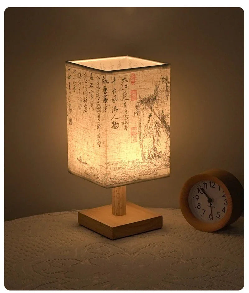 A Chinese style dimmable table lamp with a textured linen shade sits on a wooden base next to an analog clock.