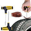 A hand holds a yellow and black tire repair tool with a needle, positioned above a tire.